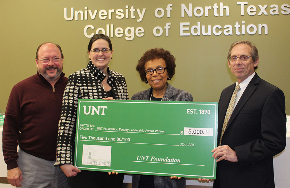 Dr. Barbara Bush is presented the 2020 UNT Foundation Faculty Leadership Award. Pictured from left are Dean Randy Bomer, UNT Provost Dr. Jennifer Cowley, Bush and Al Lockwood with the UNT Foundation.